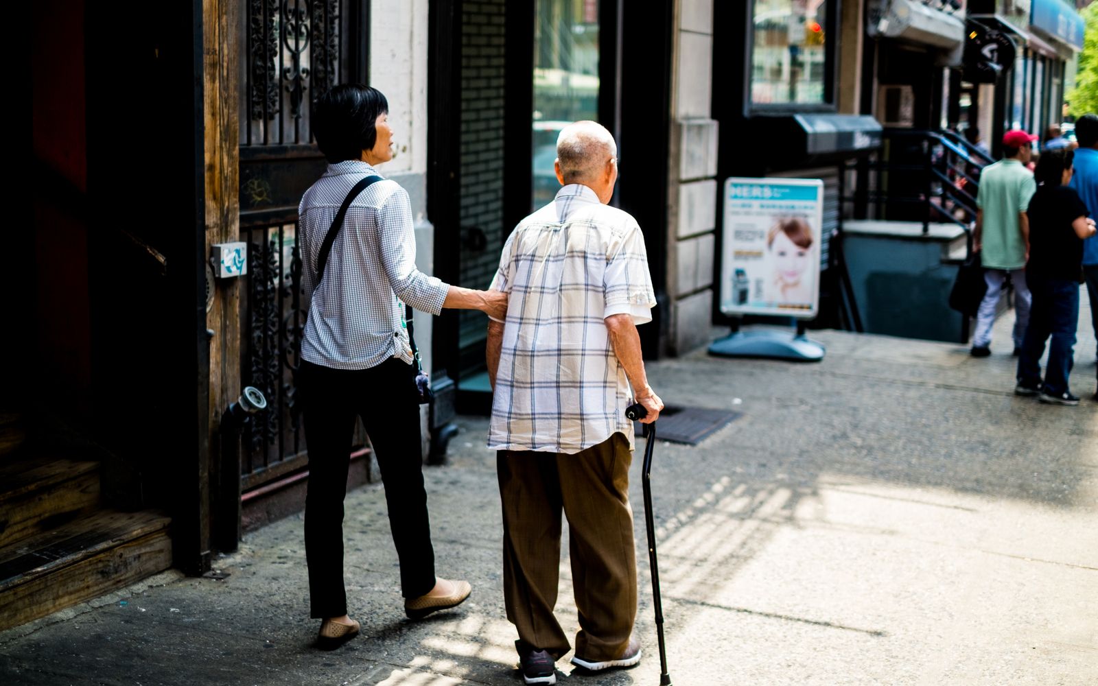 A volunteer walking alongside a senior